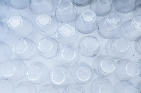 Empty plastic glasses on a white background, top view. Abstract backdrop Stock Photos