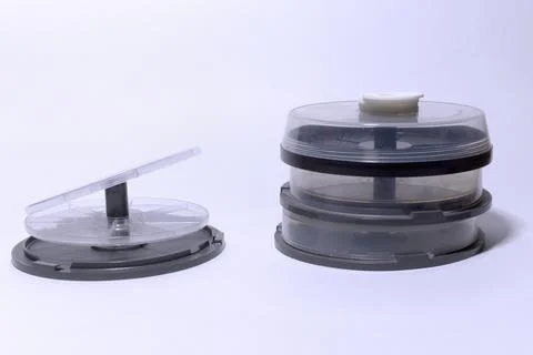 Empty plastic storages for discs. tubes with transparent covers and cake bo.. Stock Photos