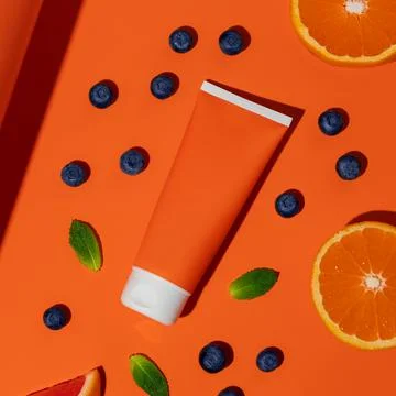 Empty plastic sun protection bottle with berries and mint Stock Photos
