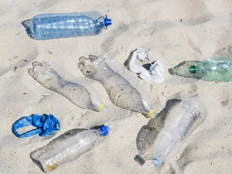 Empty plastic water bottles plastic bag sand Stock Photos