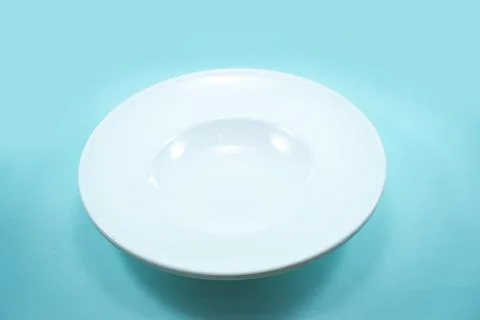 Empty plastic white plate isolated on white background. Stock Photos