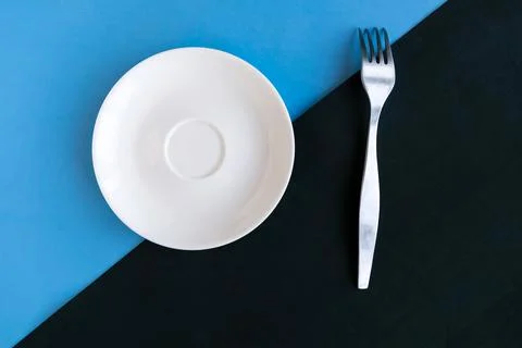 Empty plate and fork on color geometric background, minimal concept, copy spa Stock Photos