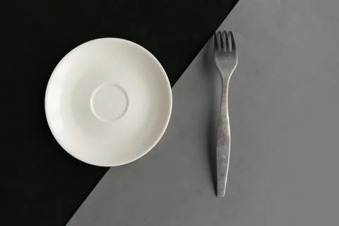 Empty plate and fork on grey and black background. Copy space for the text. M Foto stock
