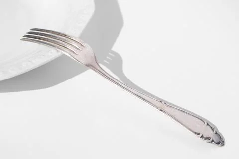 Empty plate and fork isolated with copy space - Stock Photos