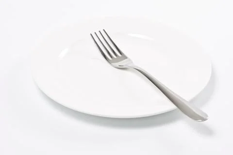 Empty plate and fork Stock Photos