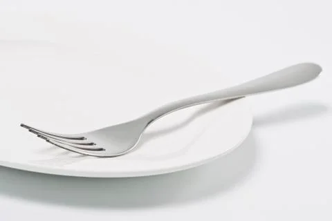Empty plate and fork Stock Photos