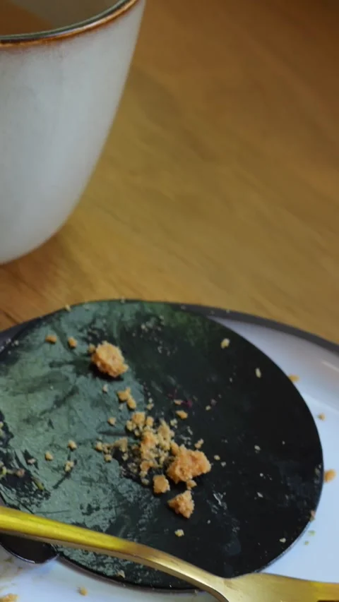 Empty plate and unfinished coffee cups with payment bills on wooden countertop Stock Footage 322127177