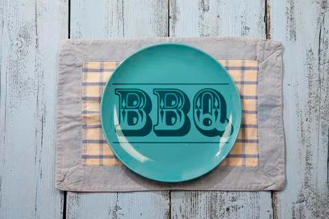 Empty plate with BBQ icon on light blue wooden background Stock Photos