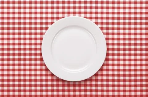 Empty plate at classic checkered tablecloth Stock Photos