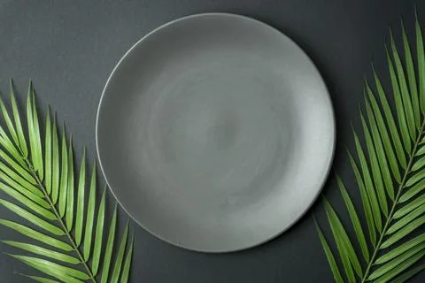 Empty plate on a dark background. Empty gray ceramic plate for food and dinner Stock Photos