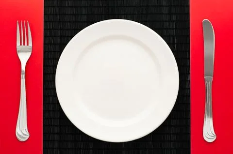 Empty plate with fork and knife Stock Photos