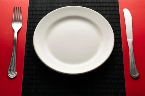 Empty plate with fork and knife Stock Photos