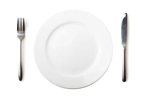 Empty plate, fork and knife - isolated over white Foto stock