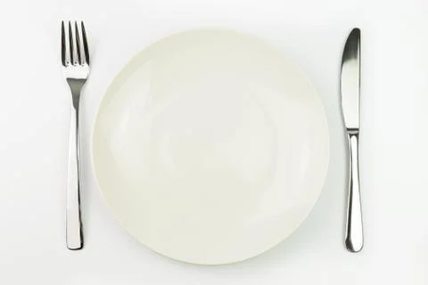 Empty plate with fork and knife Foto stock