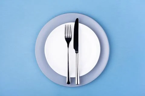 Empty plate with fork and knife. Stock Photos