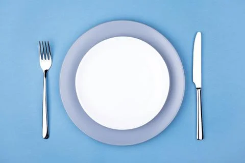 Empty plate with fork and knife. Stock Photos