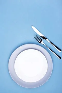 Empty plate with fork and knife. Stock Photos