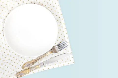 Empty plate, fork and knife on white background Stock Photos