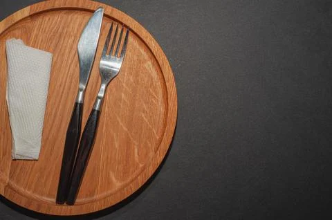 Empty plate, fork and knife. Black kitchen utensils set on stone table. fork  Stock Photos