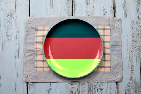 Empty plate with German flag on light blue wooden background Stock Photos