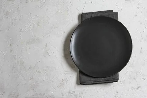 Empty plate on grey table and napkin. Food background for menu, recipe. Flatlay Stock Photos