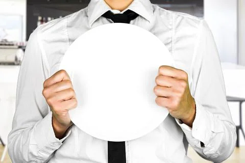 An empty plate held by a faceless waiter. Perfect shot for occupations, kitch Stock Photos