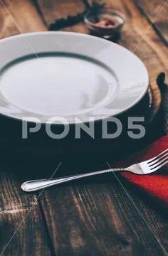 Empty plate on kitchen wooden table Stock Photos