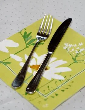 Empty plate knife and fork on a white table Photos