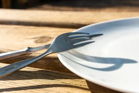 Empty plate with knife and fork Stock Photos
