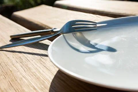 Empty plate with knife and fork Stock Photos