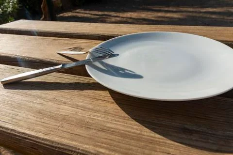 Empty plate with knife and fork Stock Photos