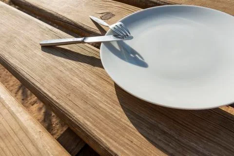 Empty plate with knife and fork Stock Photos