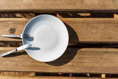 Empty plate with knife and fork Stock Photos