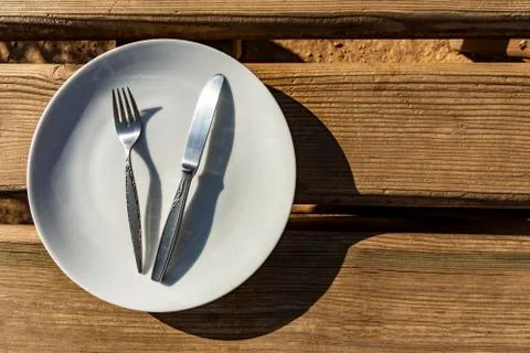 Empty plate with knife and fork Stock Photos