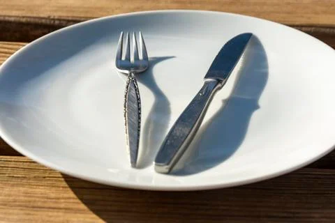 Empty plate with knife and fork Stock Photos