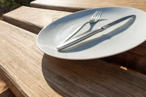 Empty plate with knife and fork Stock Photos