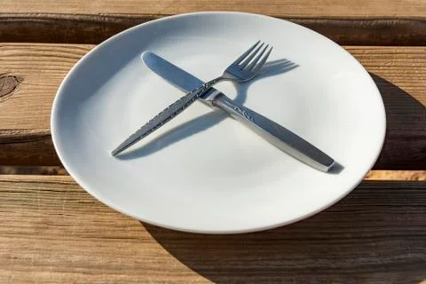 Empty plate with knife and fork Stock Photos