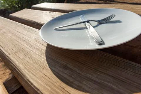 Empty plate with knife and fork Stock Photos