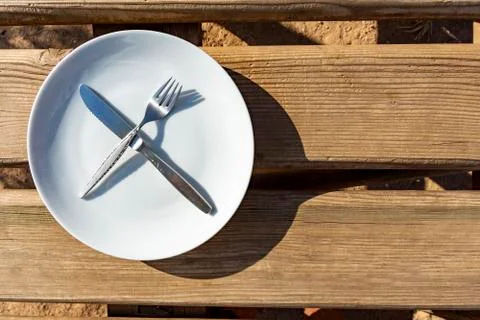 Empty plate with knife and fork Stock Photos