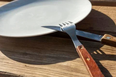 Empty plate with knife and fork Stock Photos