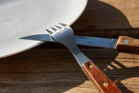 Empty plate with knife and fork Stock Photos