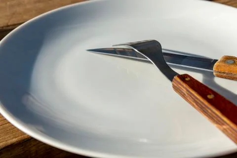 Empty plate with knife and fork Stock Photos