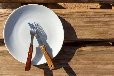 Empty plate with knife and fork Stock Photos