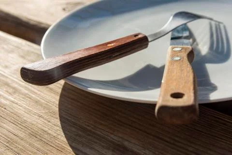 Empty plate with knife and fork Stock Photos