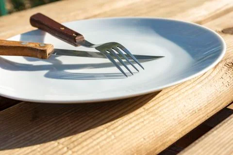 Empty plate with knife and fork Stock Photos