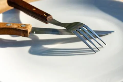 Empty plate with knife and fork Stock Photos