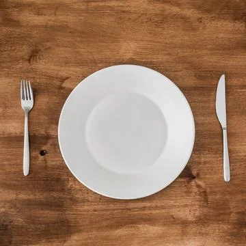 Empty plate with knife and fork Stock Photos