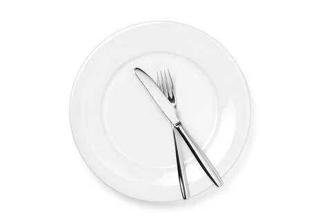 Empty plate with knife and fork isolated on a white background. Stock Photos