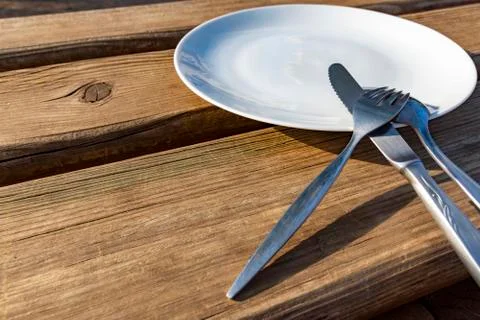 Empty plate with knife, fork and spoon Stock Photos