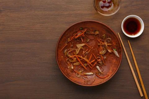 Empty plate with leftover seafood and vegetables on wooden table Stock Photos